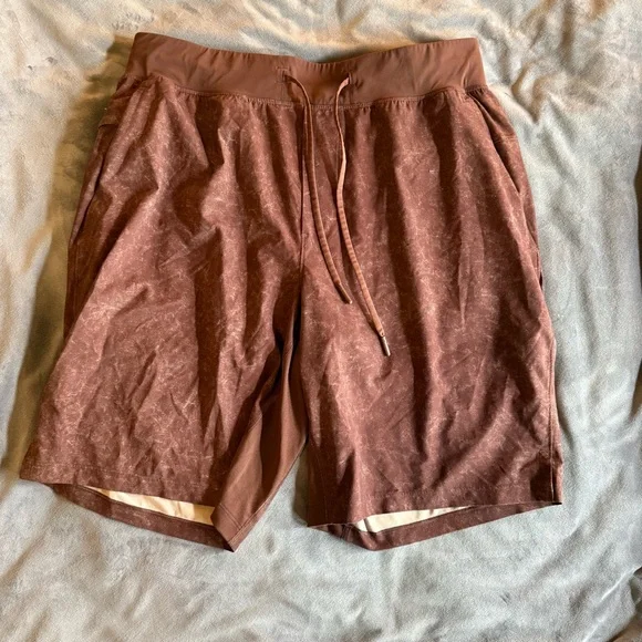 Lululemon Pace Breaker Shorts (7” inseam) in a Washed/Distressed Rust colorway. - Picture 1 of 4